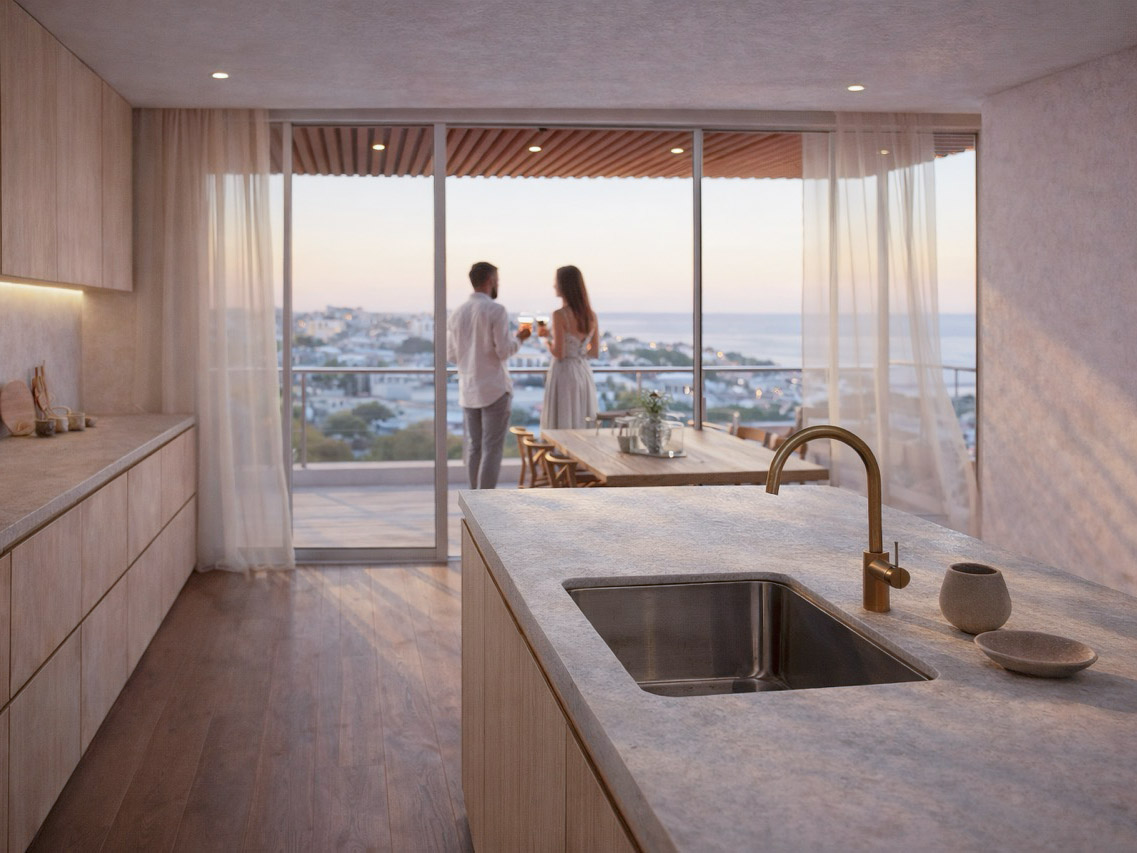 Apartment kitchen opening to a sea-view balcony